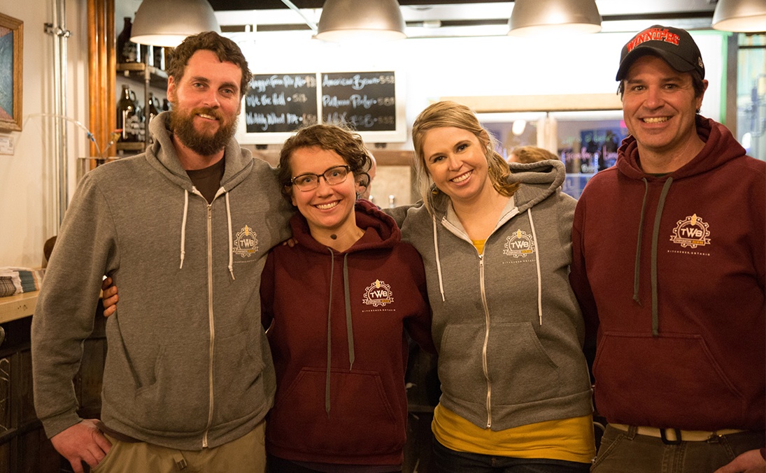 Brewers standing in their tap room