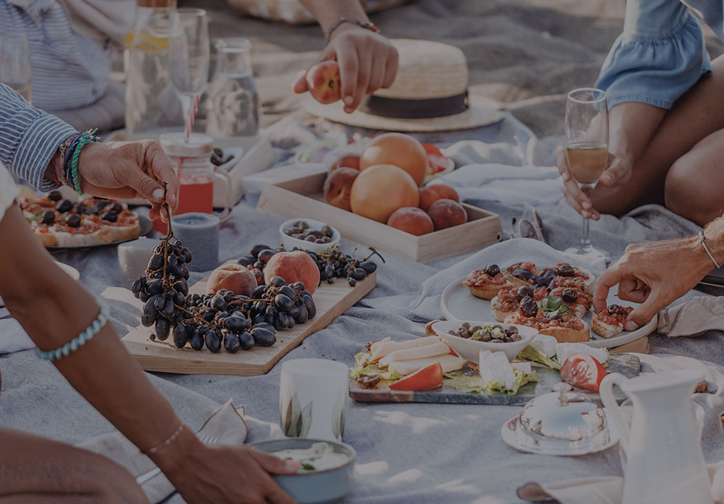 People Eating Fresh Produce and Celebrating at Beach Picnic